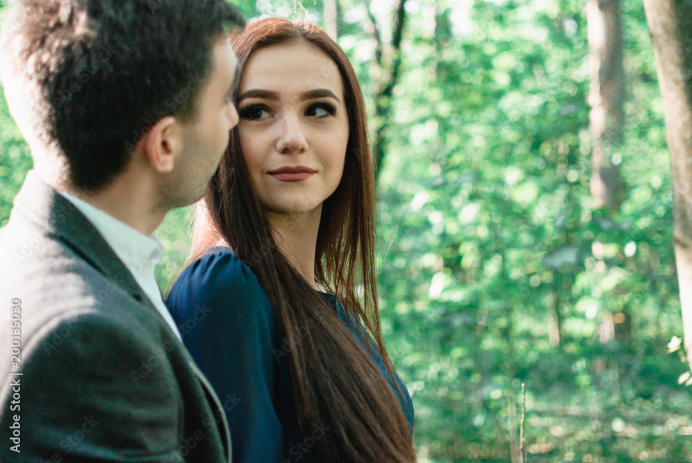 Nice outdorr portrait of young beautiful couple in love with green background Nice outdorr portrait of young beautiful couple in love with green background
