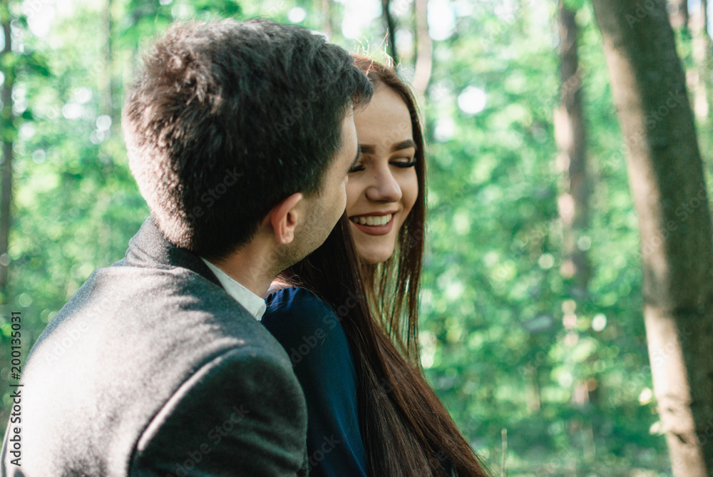 Nice outdorr portrait of young beautiful couple in love with green background Nice outdorr portrait of young beautiful couple in love with green background