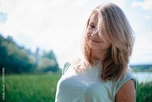 Nice outdorr portrait of young beautiful girl with green background