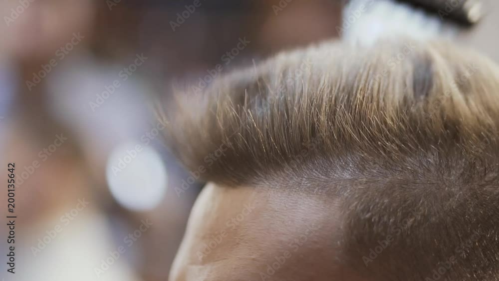 Stylist dries hair with hairdryer in salon Stylist dries hair with hairdryer in salon
