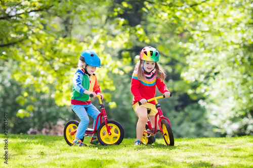 Kids ride balance bike in park © famveldman