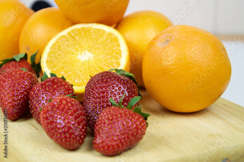 Strawberries and oranges in macro view