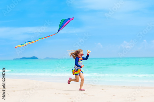 Child with kite. Kids play. Family beach vacation.