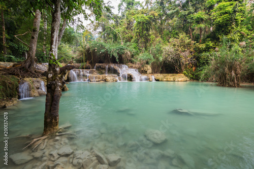 Beautiful view of small cascades and a shallow pool at the Tat Kuang Si Waterfalls near Luang Prabang in Laos.