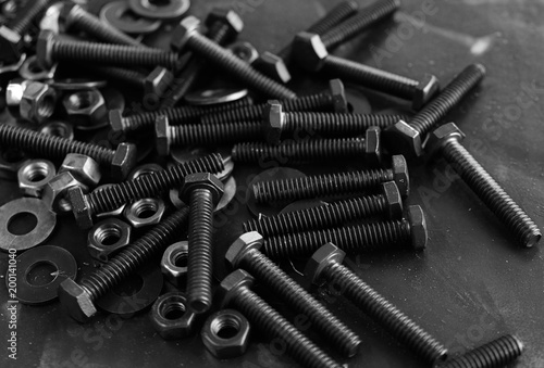 Metal screws and steel nuts and bolts in pile for construction hardware.  