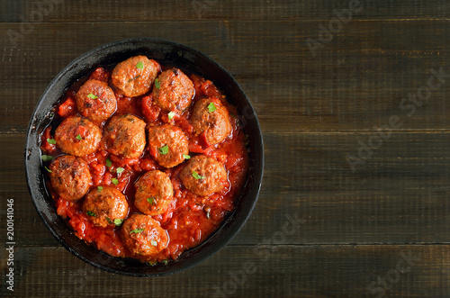 Meatballs with tomato sauce in frying pan
