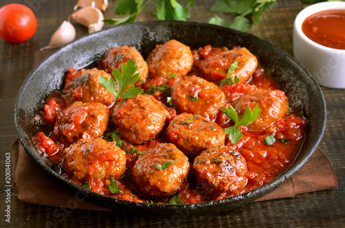 Meatballs with parsley in cast iron pan