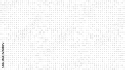 Abstract light background of small circles or pixels in various sizes in white and gray colors.