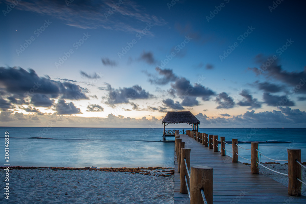Mexican sunrise over the Caribbean Sea with a jetty Mexican sunrise over the Caribbean Sea with a jetty