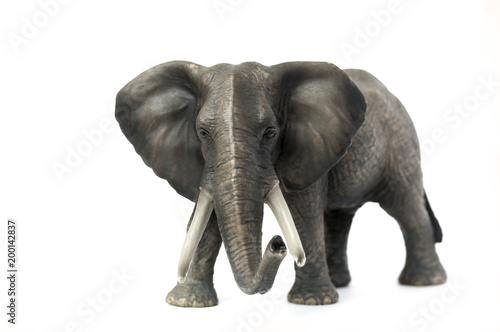 Figurine of a elephant on a white background. Front view