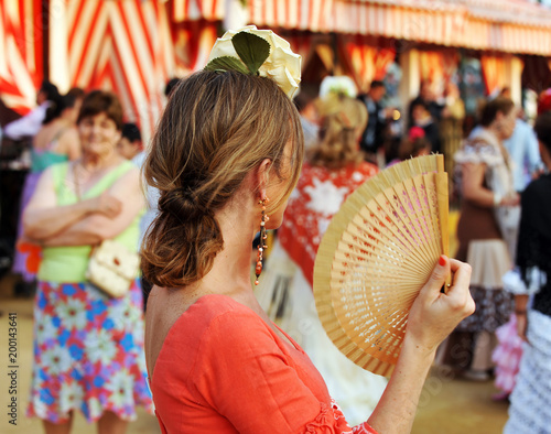 Mujer con abanico en la Feria de abril, feria de Sevilla, fiesta en España photo