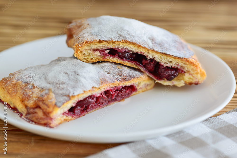 slices of strudel from puff pastry on a wooden table slices of strudel from puff pastry on a wooden table