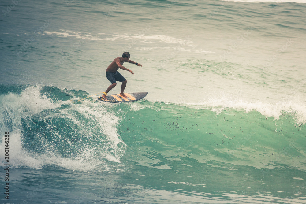 Surfer on Blue Ocean Wave, Bali, Indonesia. Riding in tube. Surfer on Blue Ocean Wave, Bali, Indonesia. Riding in tube.