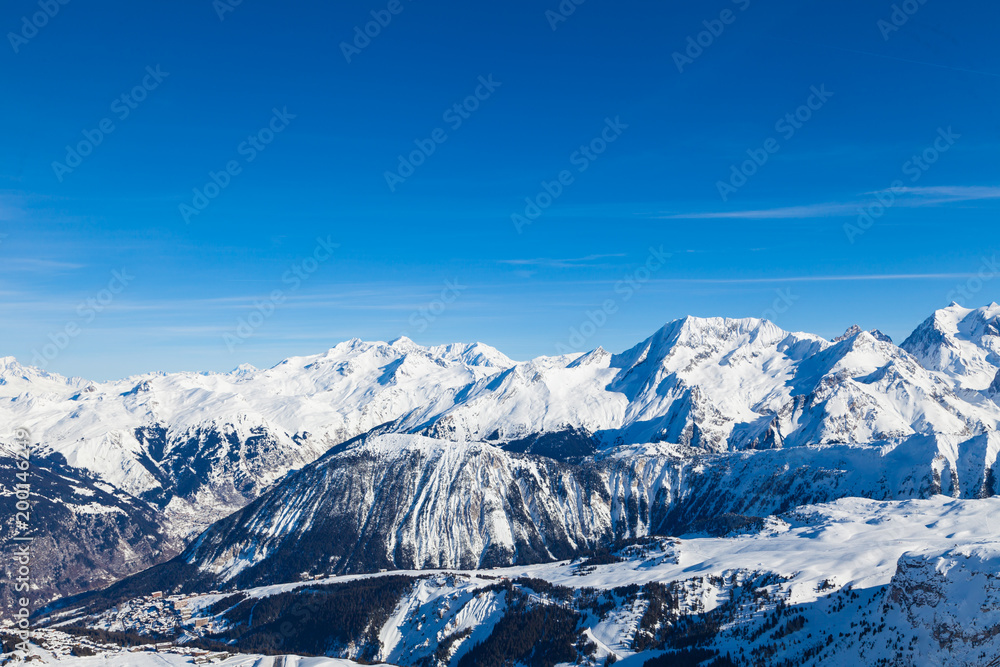 Spectacular snowy mountain panorama in cold winter. Famous ski resort in French Alps - Courchevel 1850, France. Spectacular snowy mountain panorama in cold winter. Famous ski resort in French Alps - Courchevel 1850, France.