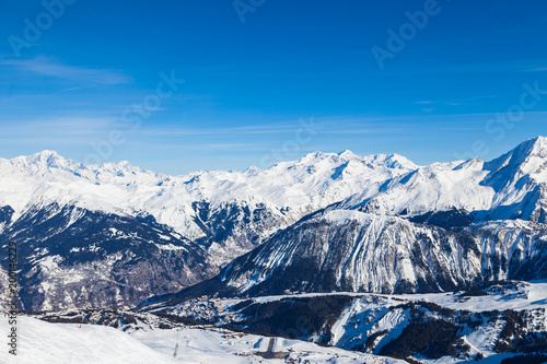 Spectacular snowy mountain panorama in cold winter. Famous ski resort in French Alps - Courchevel 1850, France.
