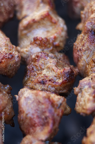 Lovely fresh pieces of smoked meat shish kebab fried on charcoal grill. Roast the meat close up