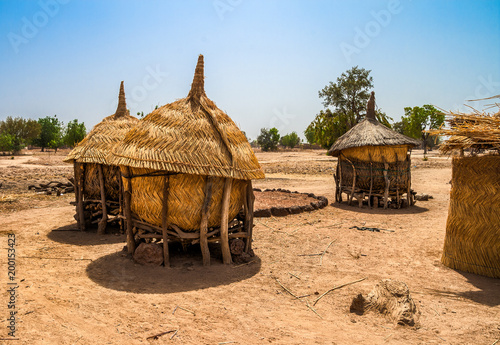 Traditional granaries made of woods and straw in an african village in Burkina Faso. They are on stilts to protect the crops against animals. photo