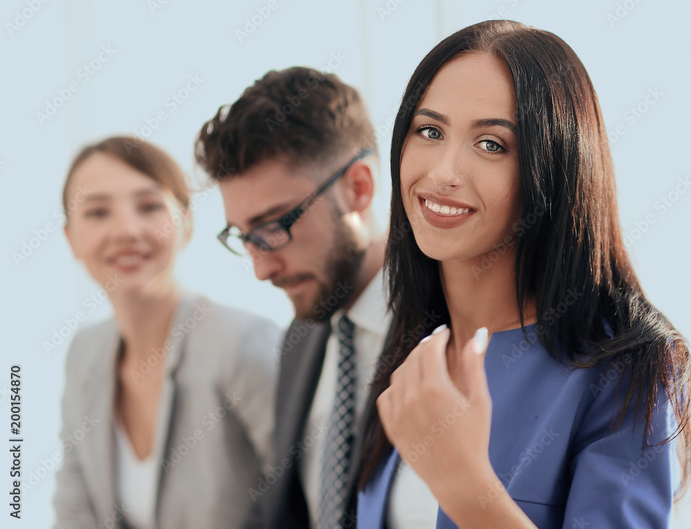 Fototapeta premium Business woman smiling with her colleagues in the background
