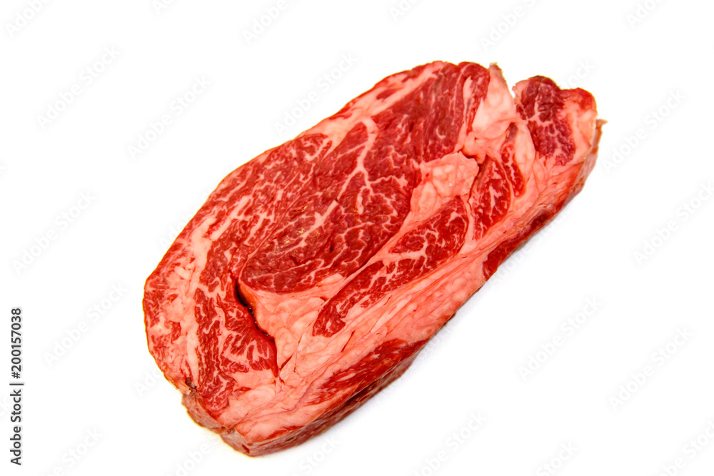 Raw marbled beef, Chuck roll steak on white background. Raw marbled beef, Chuck roll steak on white background.