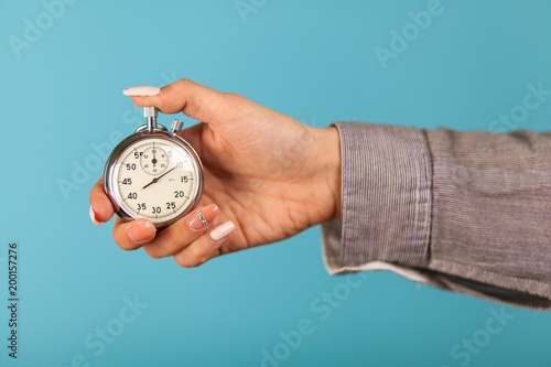 Female hand holding a stopwatch