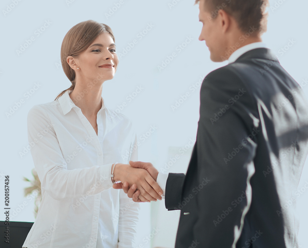 handshake young business woman with a colleague handshake young business woman with a colleague