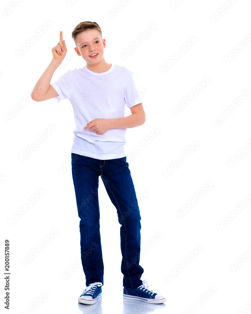 A beautiful little school boy points to something. A beautiful little school boy points to something.
