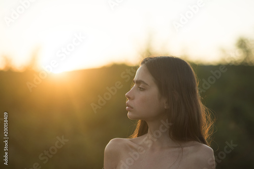 Beauty portrait of elegant young woman. sunset background. Glamour makeup. © Volodymyr
