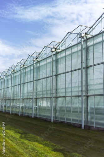 New empty big greenhouse, view outside with blue sky