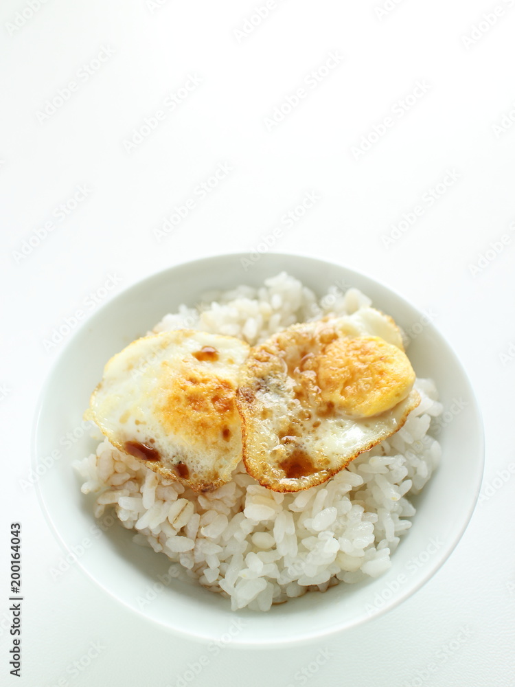 Pan fried quail eggs and soy sauce on rice