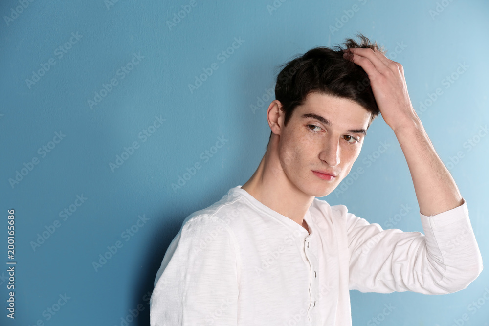 Portrait of young man with beautiful hair on color background Portrait of young man with beautiful hair on color background