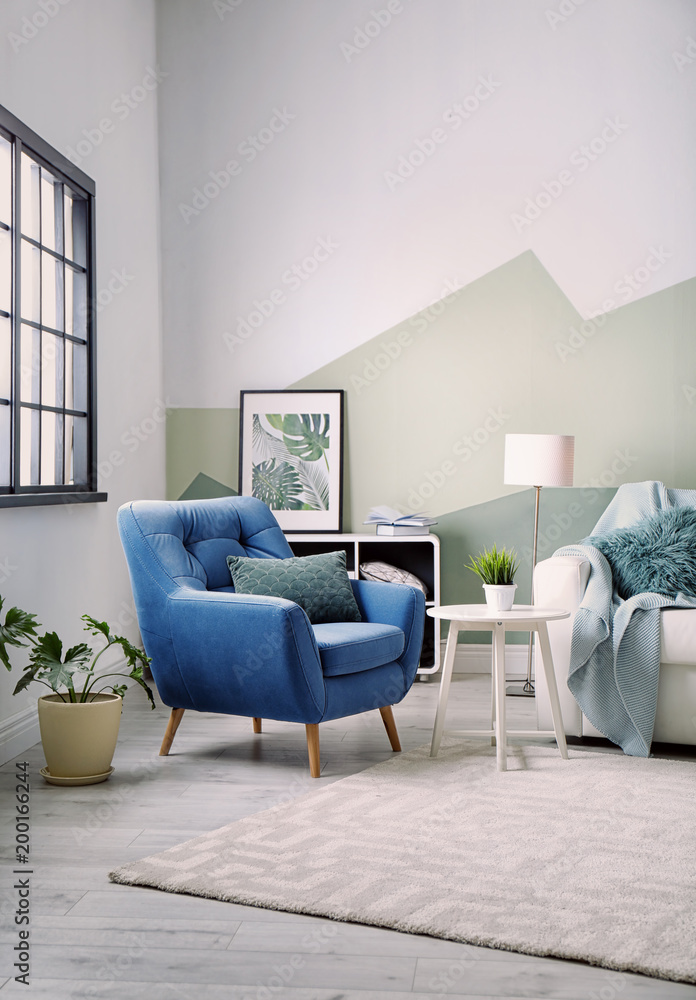 Stylish living room interior with comfortable sofa and armchair Stock ...