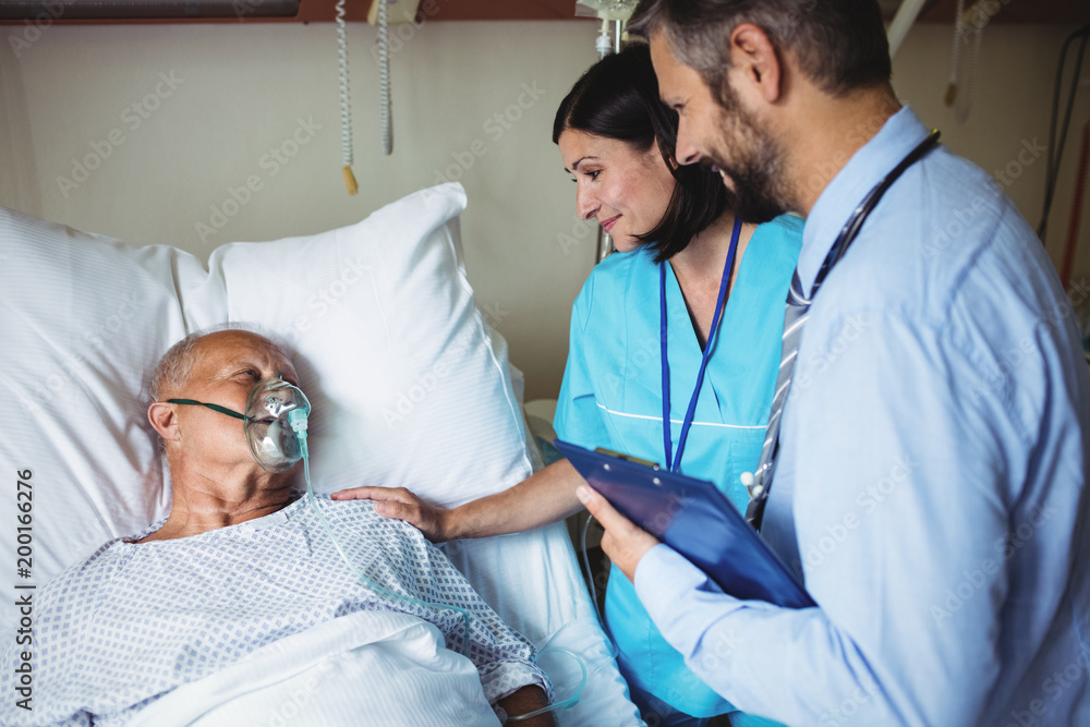 Nurse consoling senior patient with doctor Nurse consoling senior patient with doctor