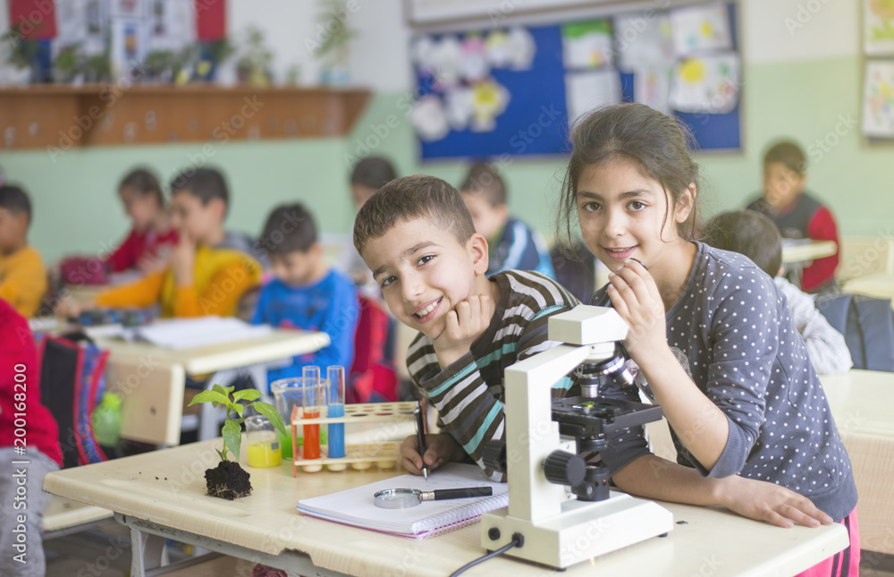 students are experimenting together with microscope students are experimenting together with microscope