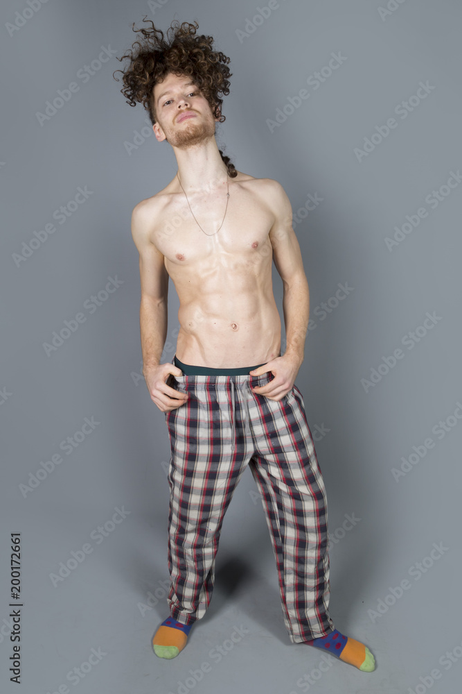 Young athletic ginger in pyjamas man studio portrait