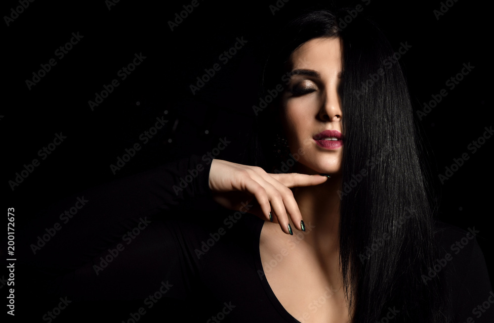 Closeup portrait of beautiful brunette girl with healthy long hair on black Closeup portrait of beautiful brunette girl with healthy long hair on black