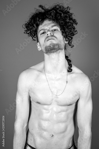 Young topless man studio portrait