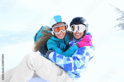 Happy couple at snowy ski r...