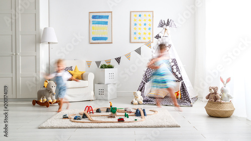 happy children playing and run  at home in   playroom