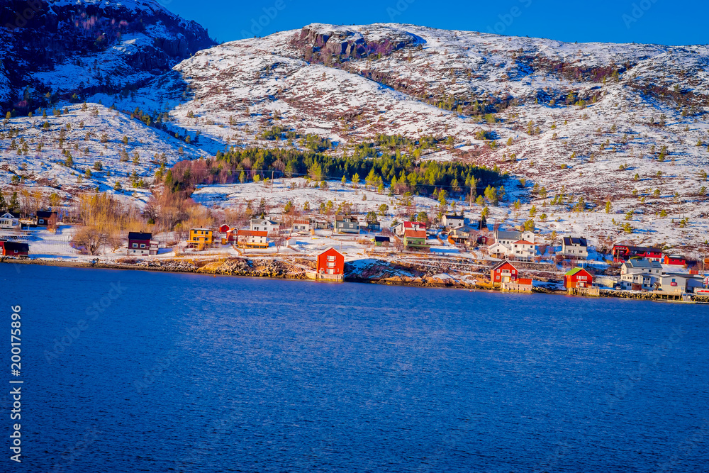 Winter views of wooden houses a long in the coast from Hurtigruten voyage, Northern Norway