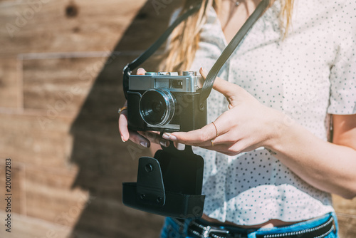 Cropped woman with vintage old camera