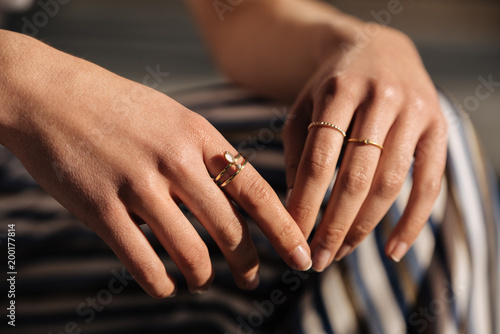 Crop woman hands with rings on the street photo