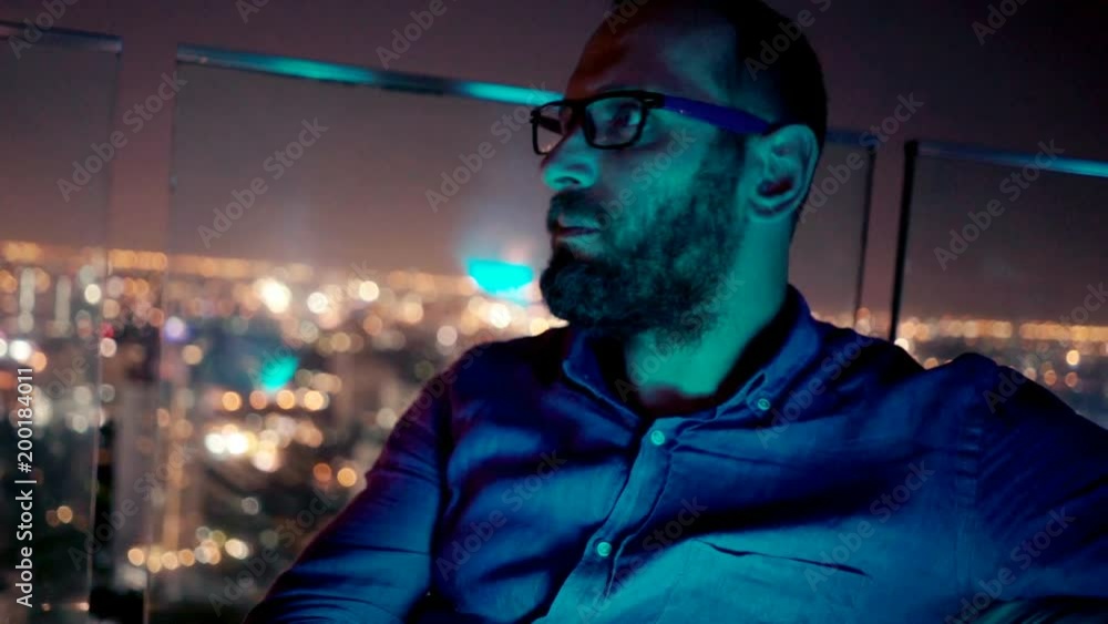 Sad, unhappy man waiting for someone in skybar during night
Sad, unhappy man waiting for someone in skybar during night