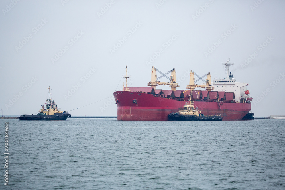 Vessel dry cargo on loading, unloading in port. Bulker in port.