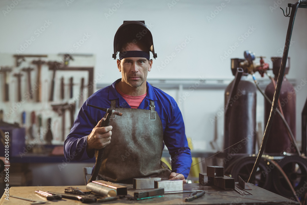 Male welder holding welding torch Male welder holding welding torch