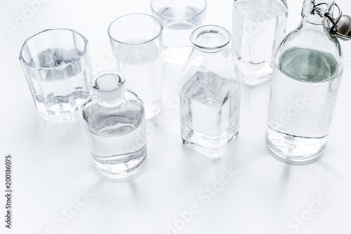 Drinks on the table. Pure water in jar and glasses on white background
