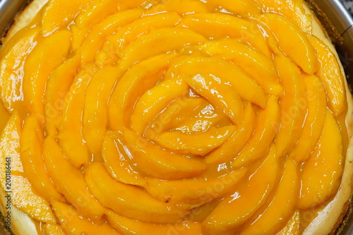 Close up of sliced mangoes from a homemade cheesecake