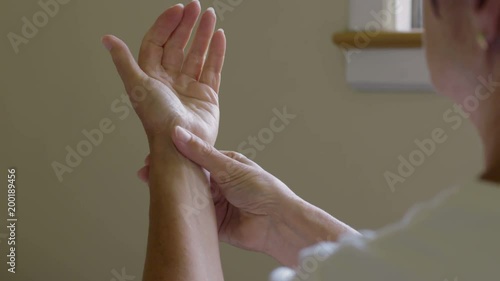 Woman massaging her arthritic hand and wrist