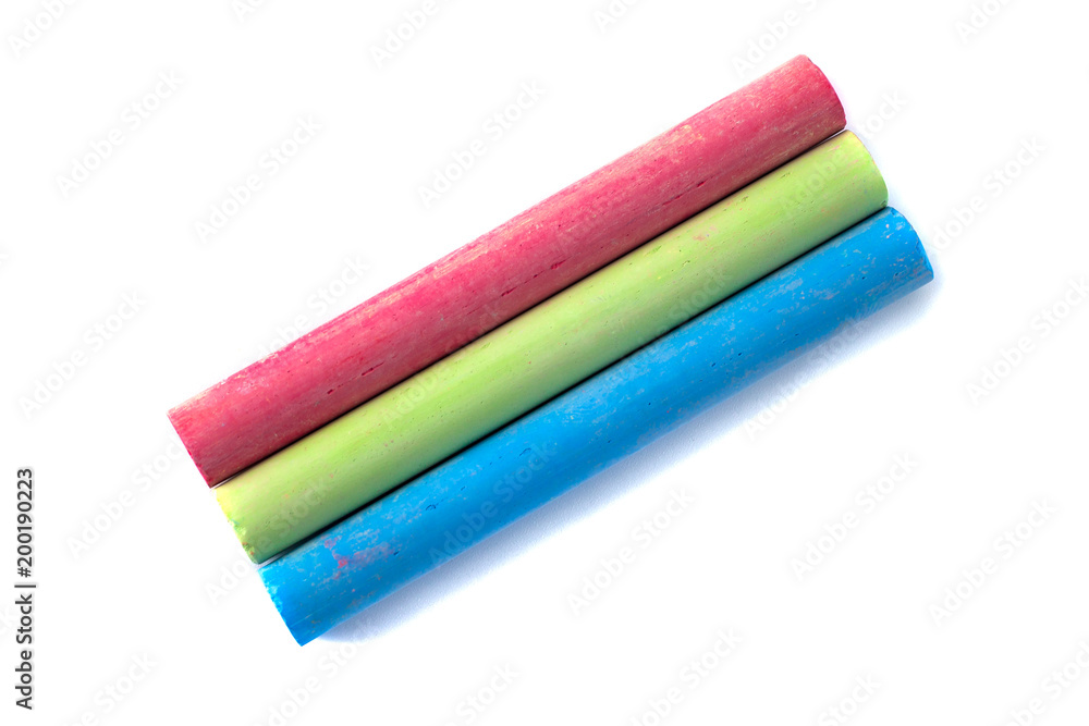 Colored chalks on white background with soft shadows Colored chalks on white background with soft shadows