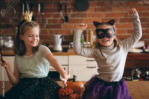 Girls in costume dancing in kitchen photo