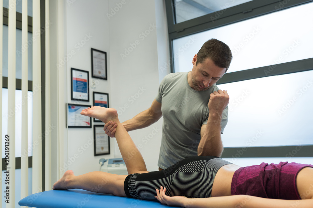 Physiotherapist giving leg massage to woman Physiotherapist giving leg massage to woman